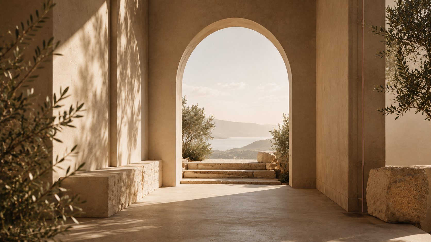 Arco de pedra abrindo para um terraço com oliveiras e vista para um vale ensolarado